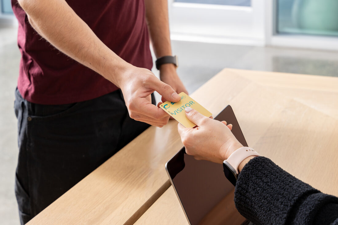 A pass handed across a reception desk