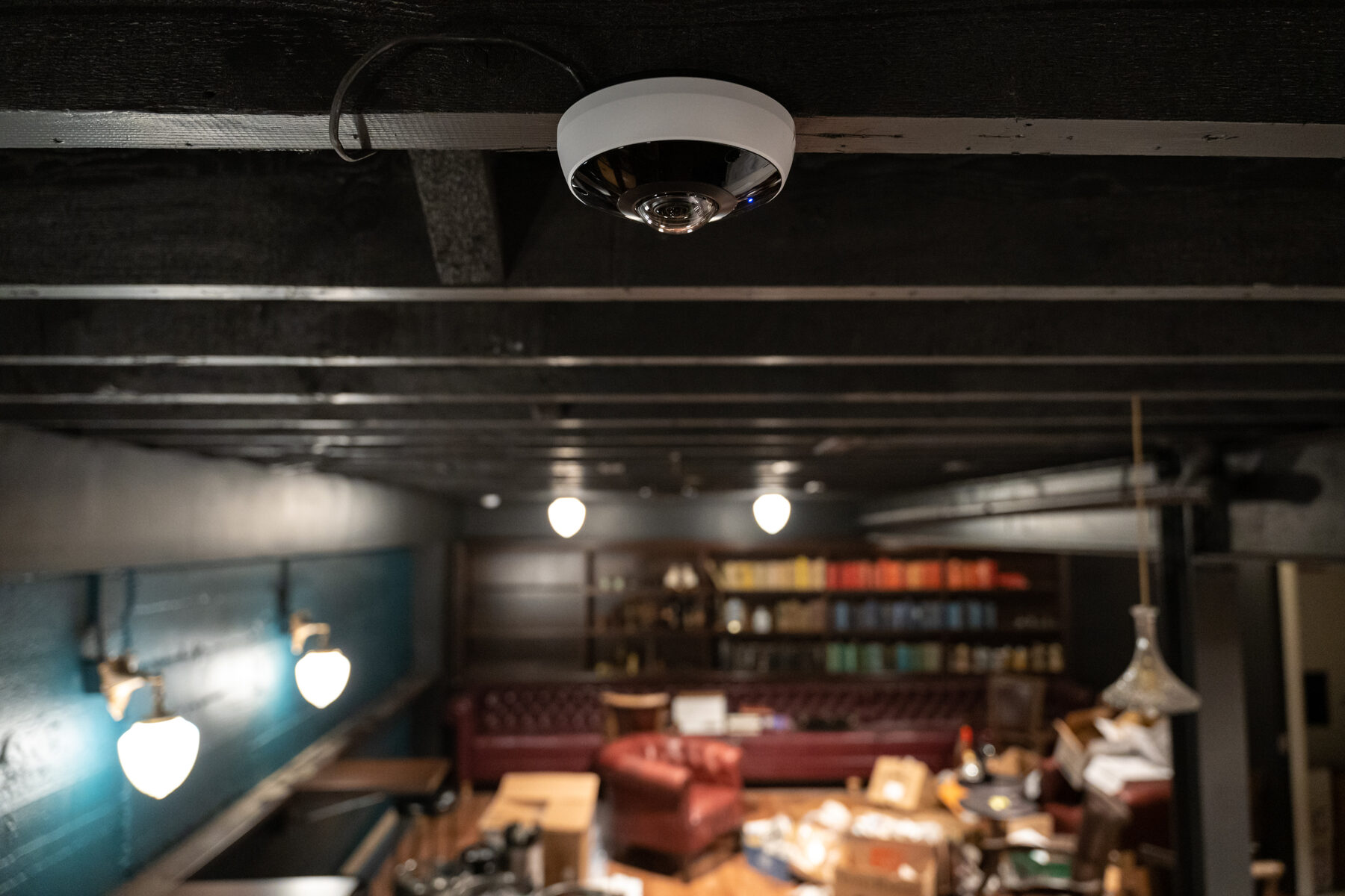 The interior of a bar with cameras above the servery