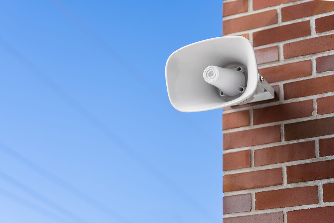 A loudspeaker on the outside wall of a building